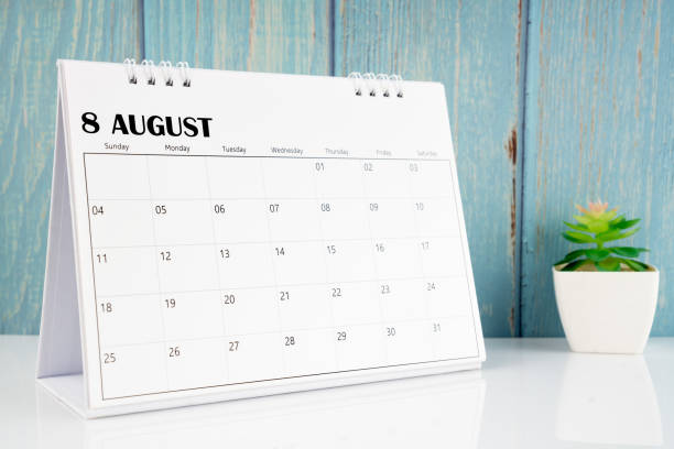 istock August 2024 calendar on the white table with wooden background. 2154811591
