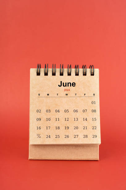 istock June 2024 white mini desk calendar on red background. 2154811592