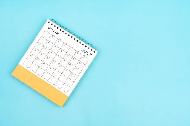 istock 2024 July Desk Calendar On Blue Background. Composition with copy space. 2154811617