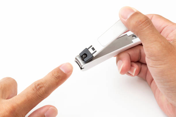 istock A man's hand cutting his nails. 2154814386