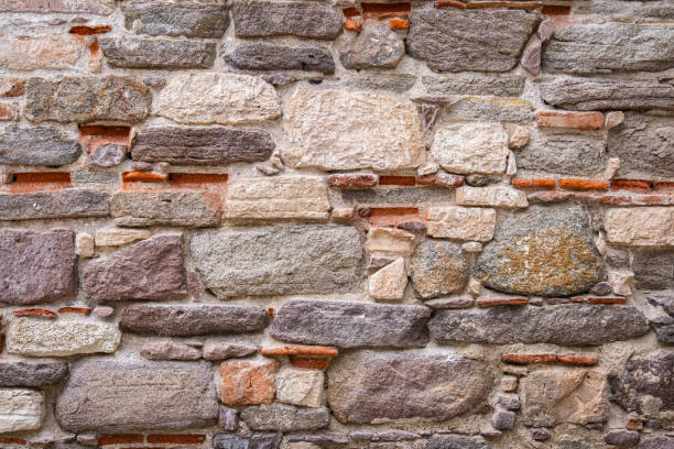 istock Historic stone wall. rough, old and worn ancient surface. big rock pieces. 2154814579