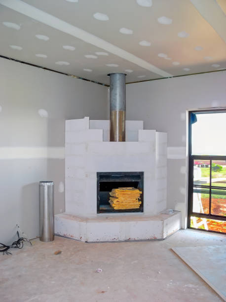 Empty Scandinavian-style room with modern fireplace, stacked firewood, concrete floor, and ocean-view window. Minimalist and natural design. 3D rendering.