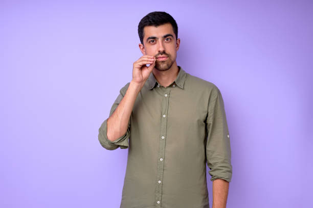 istock Young serious bearded deaf mute man wants to drink tea 2154817423