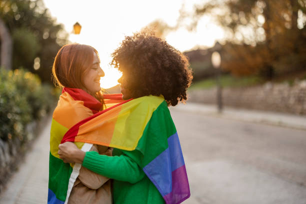 istock Friends Wrapped in Rainbow Flag 2154818623