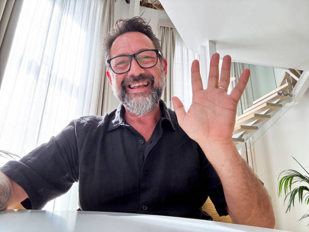 istock Cheerful adult man enjoy videocall using laptop. Web camera view. Gesturing and smiling with friends online. Happy business solution. Modern worker video call team. Smart working happiness freedom 2154820326