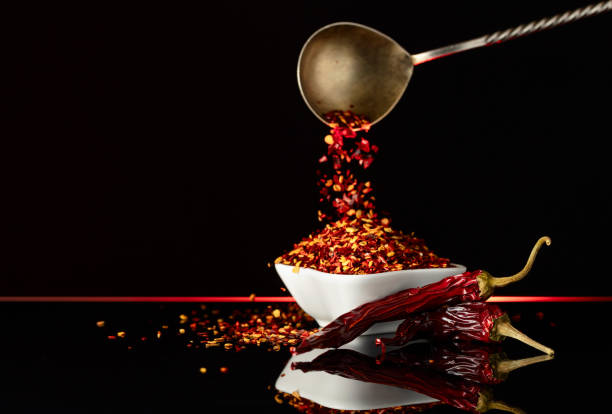 istock Red pepper flakes pour in white bowl. 2154821759