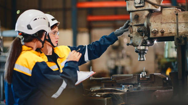 istock Female factory workers inspect machinery. 2154824372
