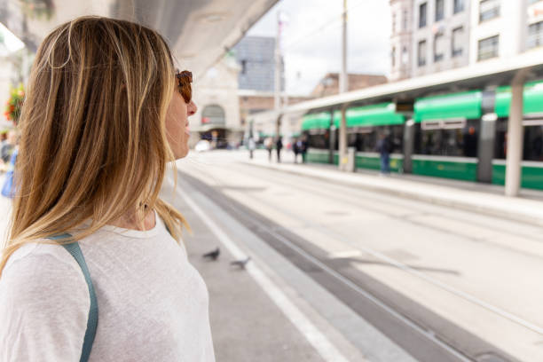 istock Woman Observing at Tram Station 2154824383