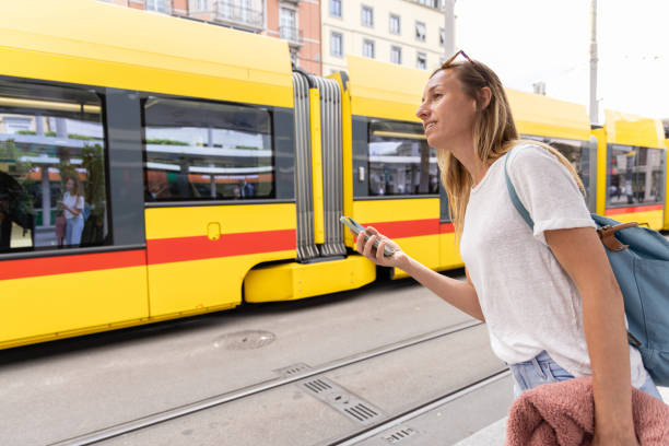istock Young Woman Waiting for Tram with Smartphone 2154824486