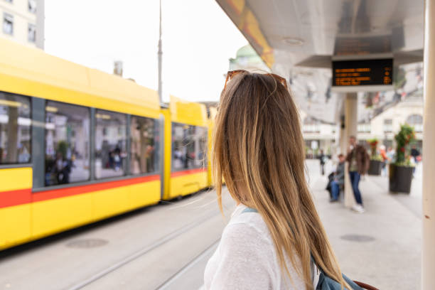 istock Woman Observing Tram at City Station Platform 2154824507