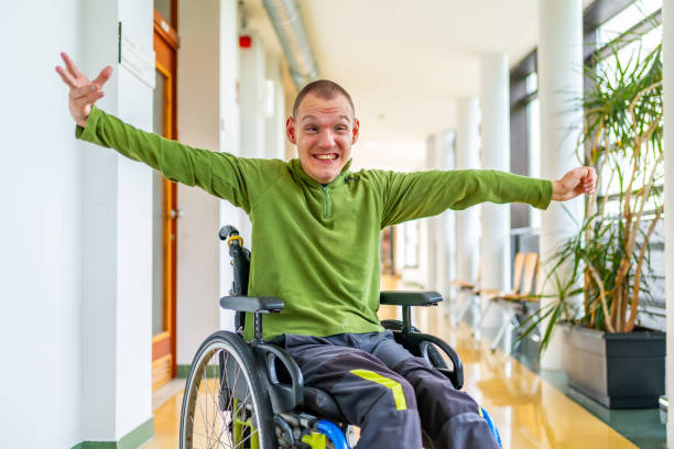 istock Man with cerebral palsy celebrating he is in the university 2154824529