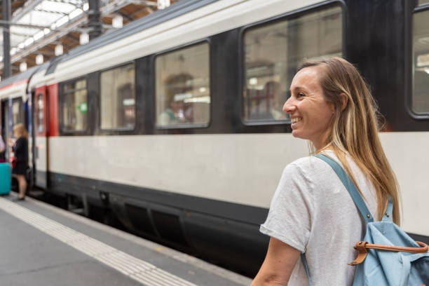 istock Smiling Woman with Backpack at Train Station 2154824565