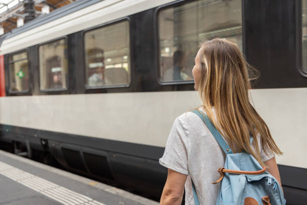 istock Woman with Backpack Waiting at Train Station 2154824568