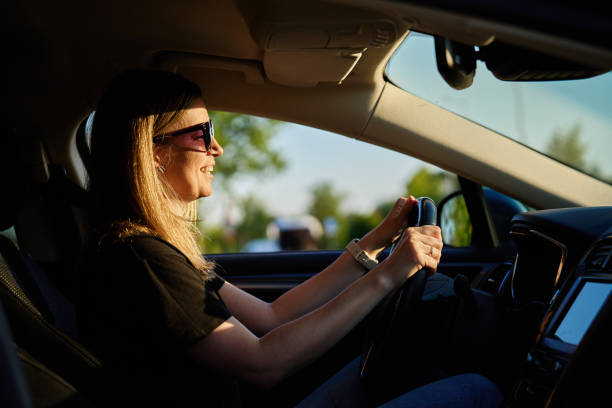 istock Happy woman is sitting in car. View through windshield 2154824627