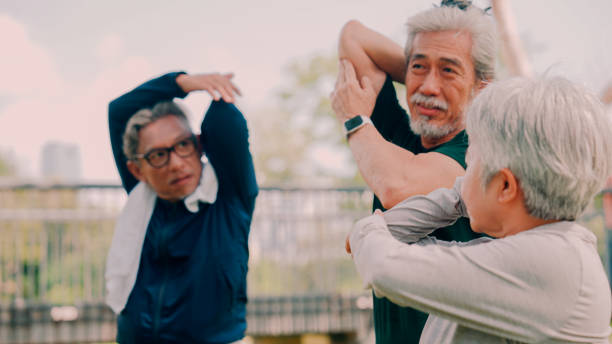 istock Group of elderly people exercising in the garden . 2154824720