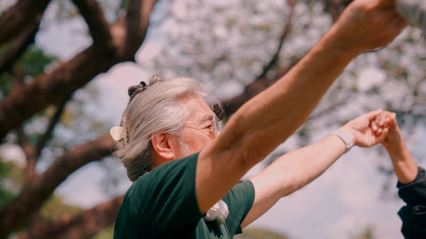 istock Asian senior man meditating together outdoors in nature. 2154824792
