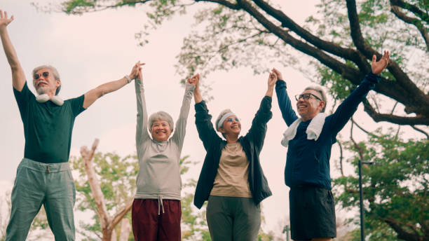 istock Group of senior meditating together outdoors in nature. 2154824829