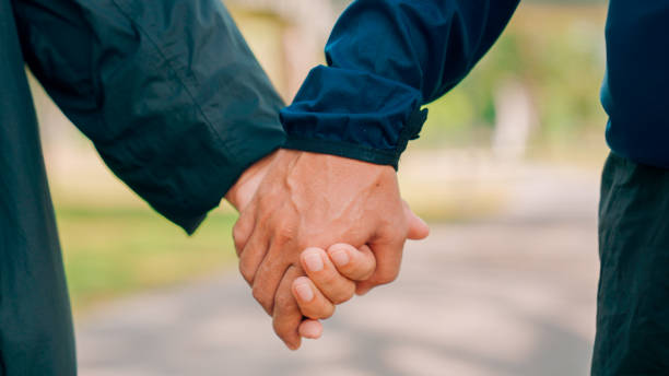 istock Close up hands senior couple in the park. 2154824878