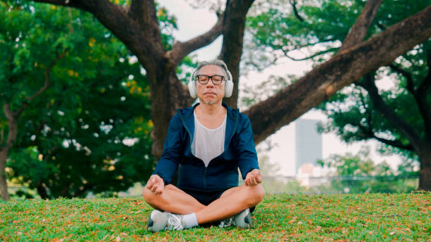 istock Asian senior man practicing yoga outdoor, finding harmony in meditation. 2154824910