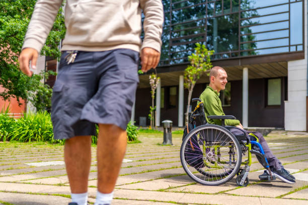 istock Disabled man waiting for a university colleague int he campus 2154825028