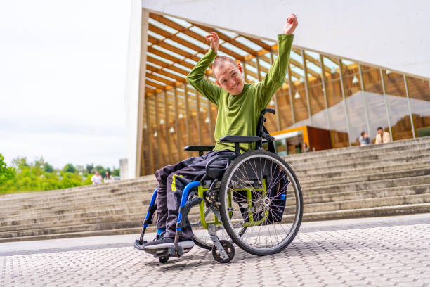 istock Disabled man raising arms proud to be in the university 2154825076