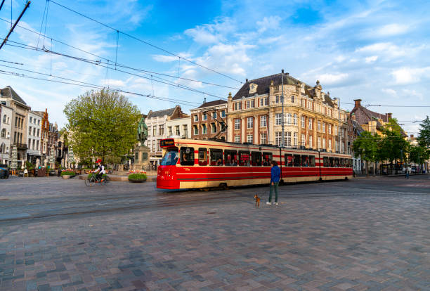Amsterdam, Netherlands - July 09, 2023: Magna square Commercial center in a old palace and the city tram of Amsterdam in the Dam Square. Netherlands.
