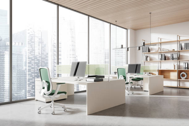istock Modern coworking interior with pc monitors and armchairs in row, window 2154828559