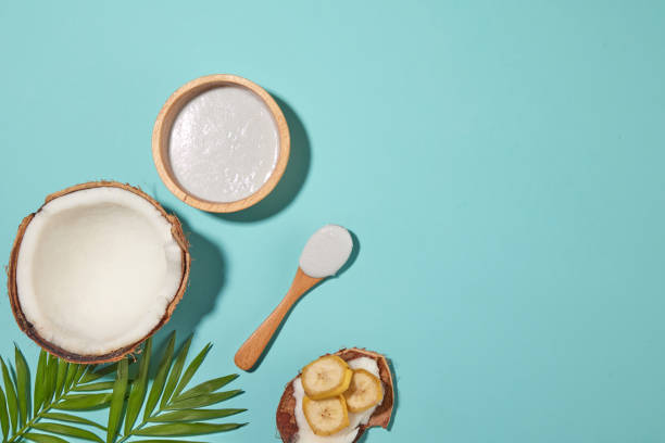 istock Design template with tropical fruit ingredient including coconut and banana, it placed on blue table top with blank space on the right side for showing product of fruit extract, top view shot 2154828604