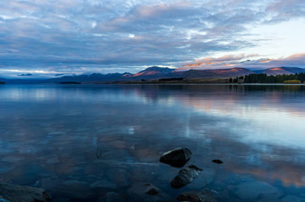 istock Lake Tekapo and the cloudy mountains in the evening 2154828640