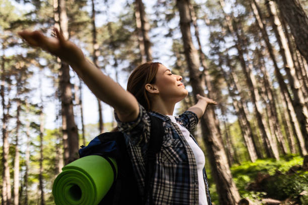 istock Young Woman Celebrating with Arms Raised 2154829220