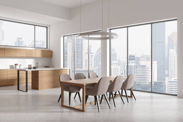 istock Stylish home kitchen interior with eating table, bar island and cabinet, window 2154829610