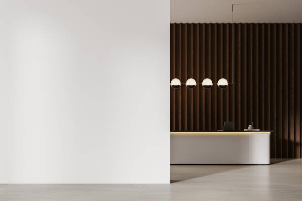 istock Stylish office reception interior desk with laptop, mockup wall 2154830797