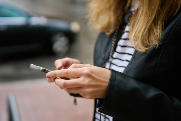istock Woman using smartphone at city street 2154833196