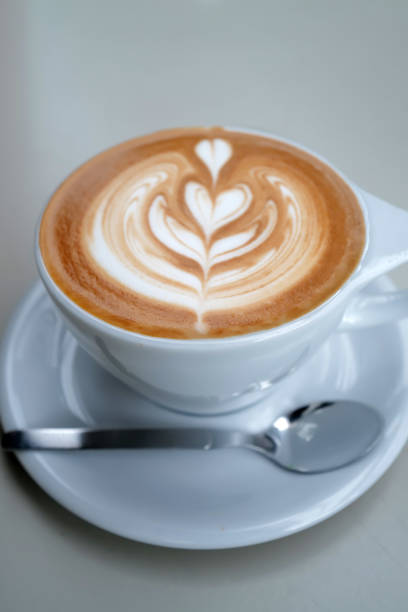 istock Close up ceramic cup of hot Latte art coffee on white table 2154834863
