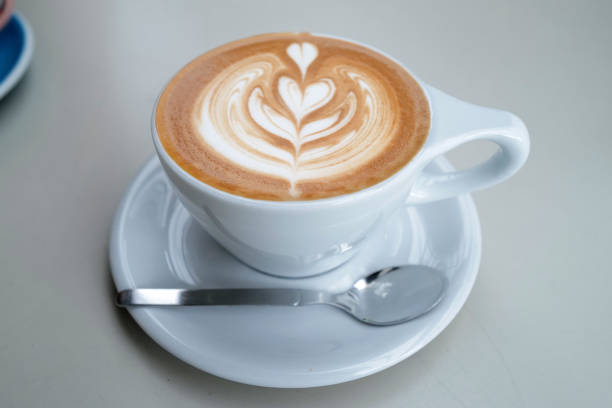 istock Close up ceramic cup of hot Latte art coffee on white table 2154834899