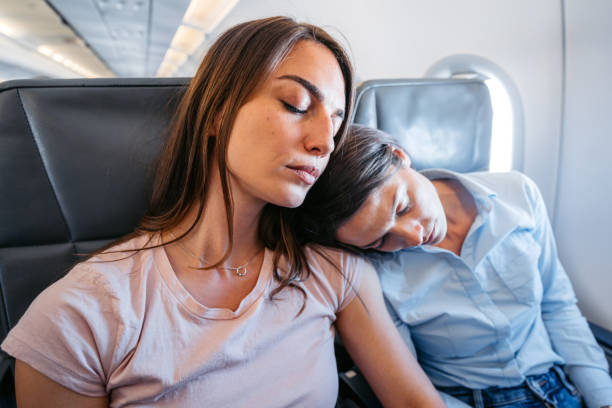 istock Two Young Female Friends Sleeping In An Airplane 2154835335