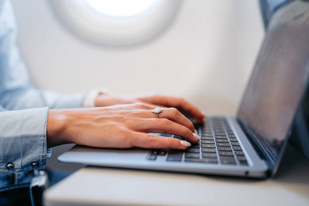 istock Young Woman Working On Her Laptop In An Airplane 2154836150