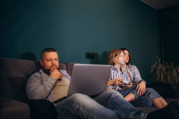 istock a young family on the couch at home 2154836185