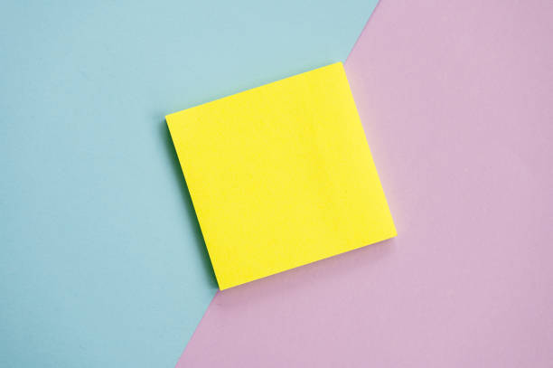istock Top view of yellow sheets stickers on a blue and purple background Mockup with a notebook , sheets for notes 2154838057