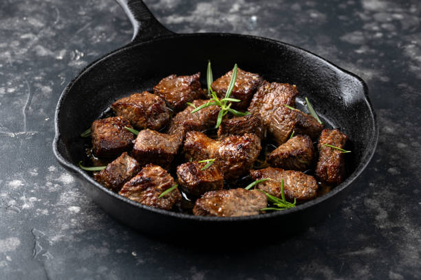 Garlic butter beef steak bites in iron cast pan