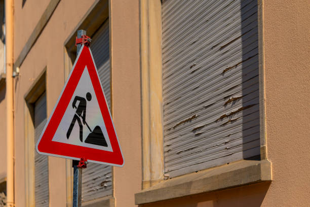 a street sign with a man holding a shovel