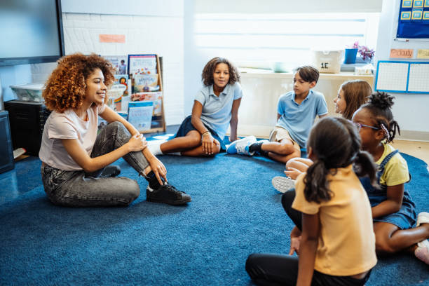 istock Latina teacher stretching with pupils in classroom between classes 2154841986
