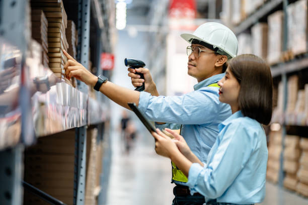 istock Warehouse staff working together using digital tablets to check the stock inventory on shelves in large warehouses, smart warehouse management system, supply chain, logistic network technology concept 2154842318