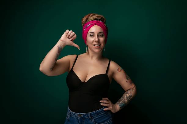 istock Woman With Pink Headband Pointing at Camera 2154844550