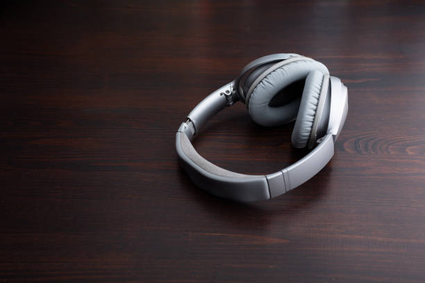 Old style vintage headphones flat lay on concrete background