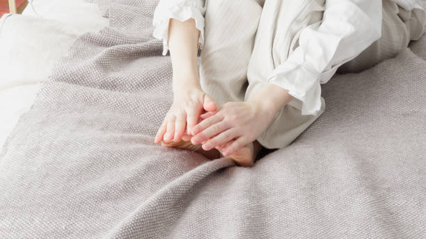 istock A woman rubbing her cold feet 2154845183