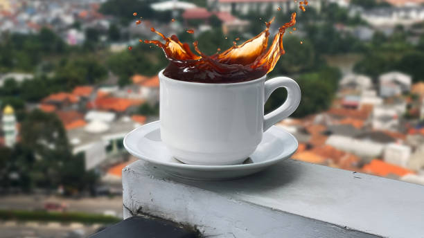 a splash of cup of coffee on the edge of the building's balcony