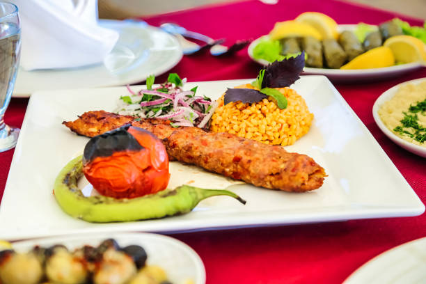 A red table covered with various plates of delicious food, ready to be enjoyed.