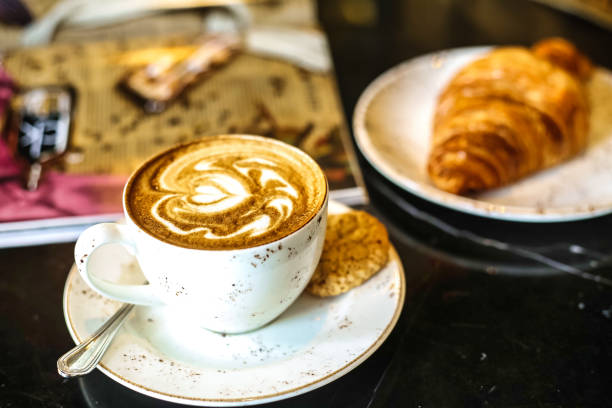 istock Cup of Coffee and Croissant on Table at a Cafe 2154845543