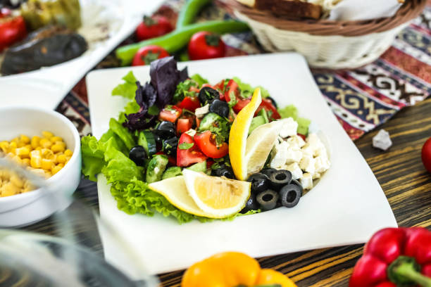 istock Fresh Salad on White Plate Next to Bowl of Corn 2154845680